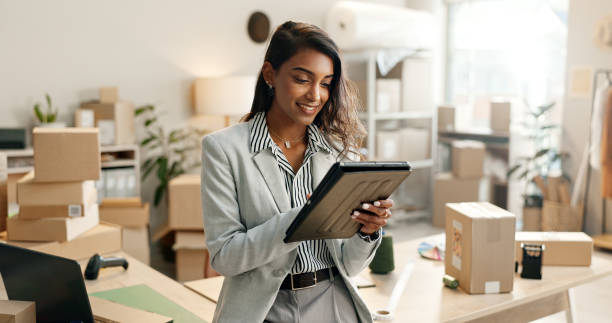 How to Build a Ecommerce Store - Small business, woman and tablet for e commerce, startup and inventory management of online shop, order or courier. Entrepreneur or Indian seller on digital technology for logistics, boxes or package